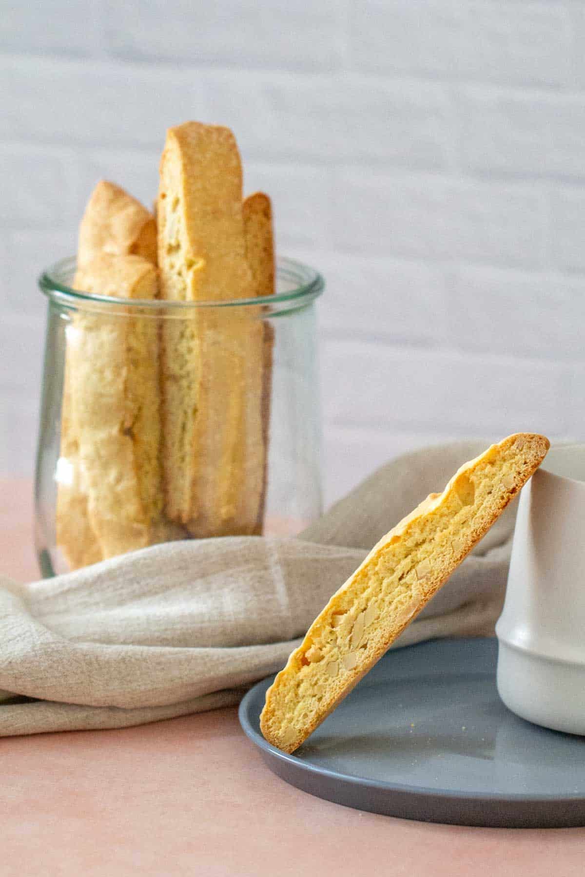 almond biscotti leaning on a coffee cup