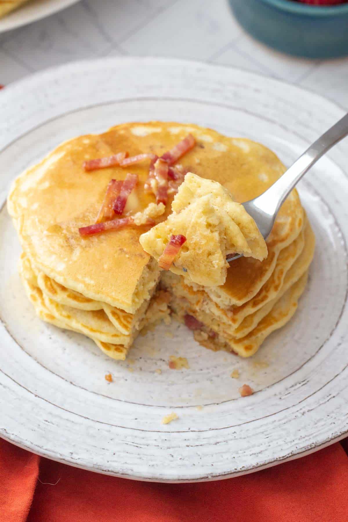 fork holding pieces of bacon pancakes