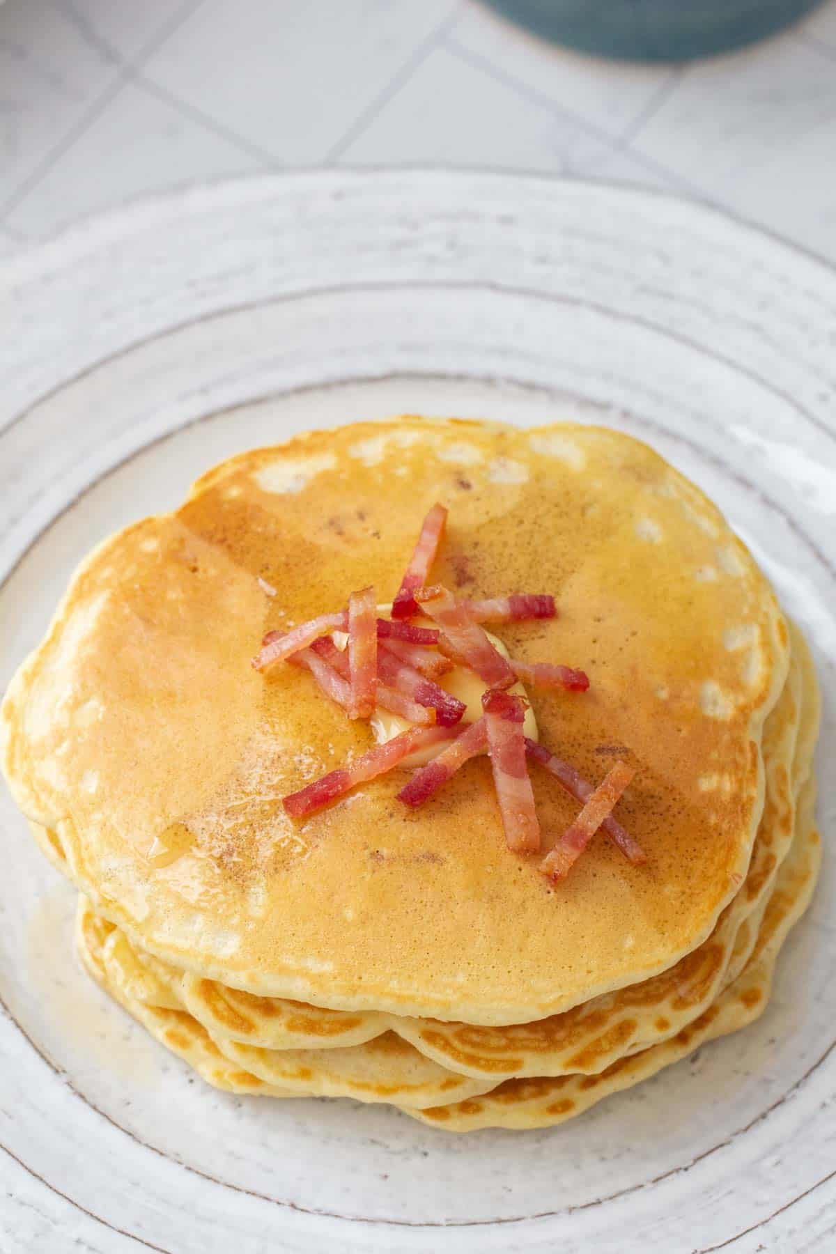 plate of bacon pancakes with chopped bacon on top