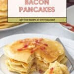 A stack of bacon pancakes with crispy bacon pieces on a white plate, a forkful removed. More pancakes and syrup tempt in the background. Text reads: "Bacon Pancakes. Get the recipe at stetted.com.