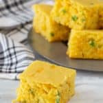 square of jalapeno cornbread on gray surface