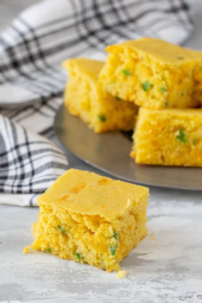 square of jalapeno cornbread on gray surface