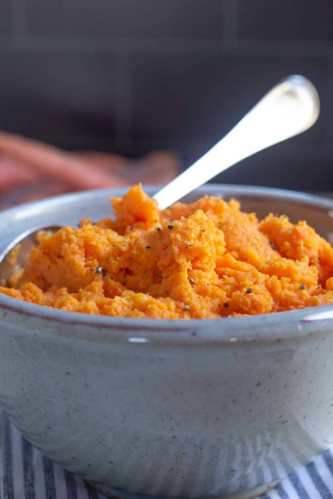 mashed carrots in gray bowl