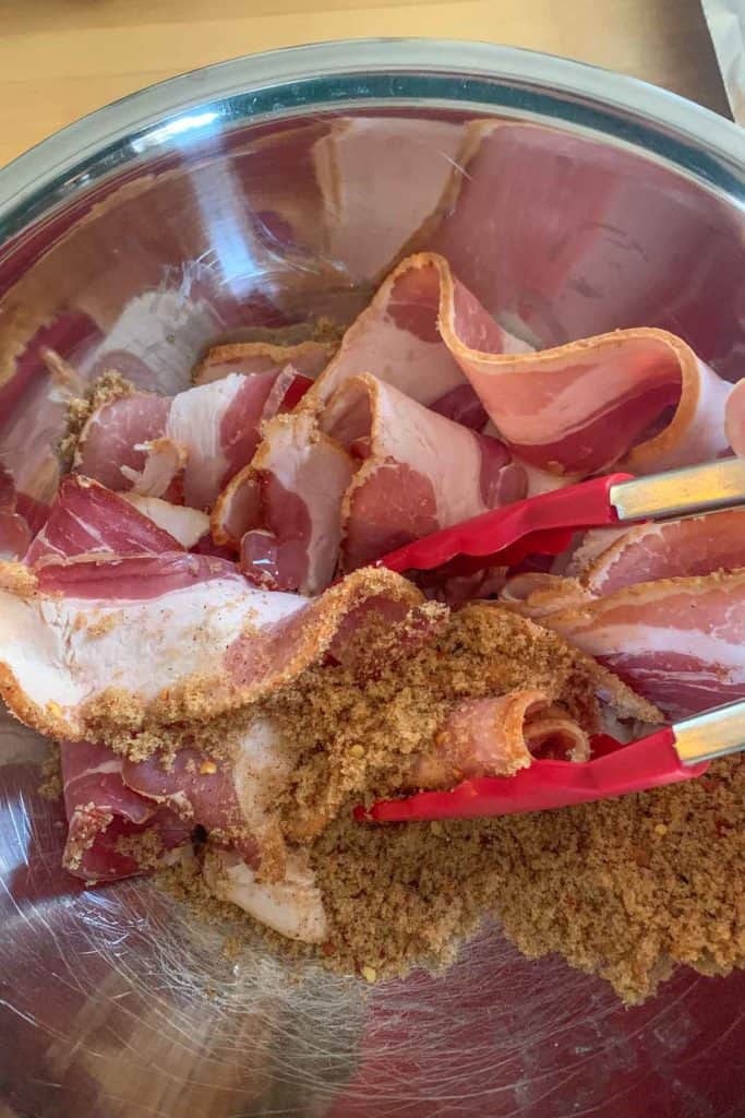 tossing bacon in spices and sugar