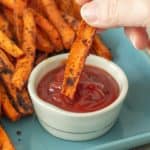 carrot fries dipping into ketchup