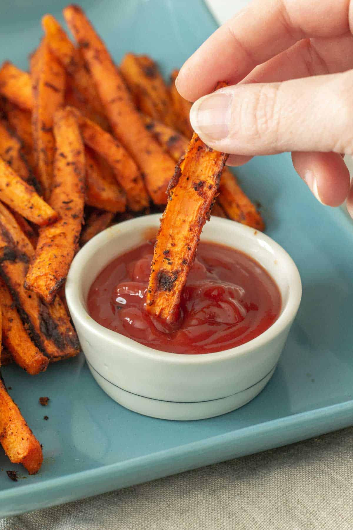 carrot fries dipping into ketchup