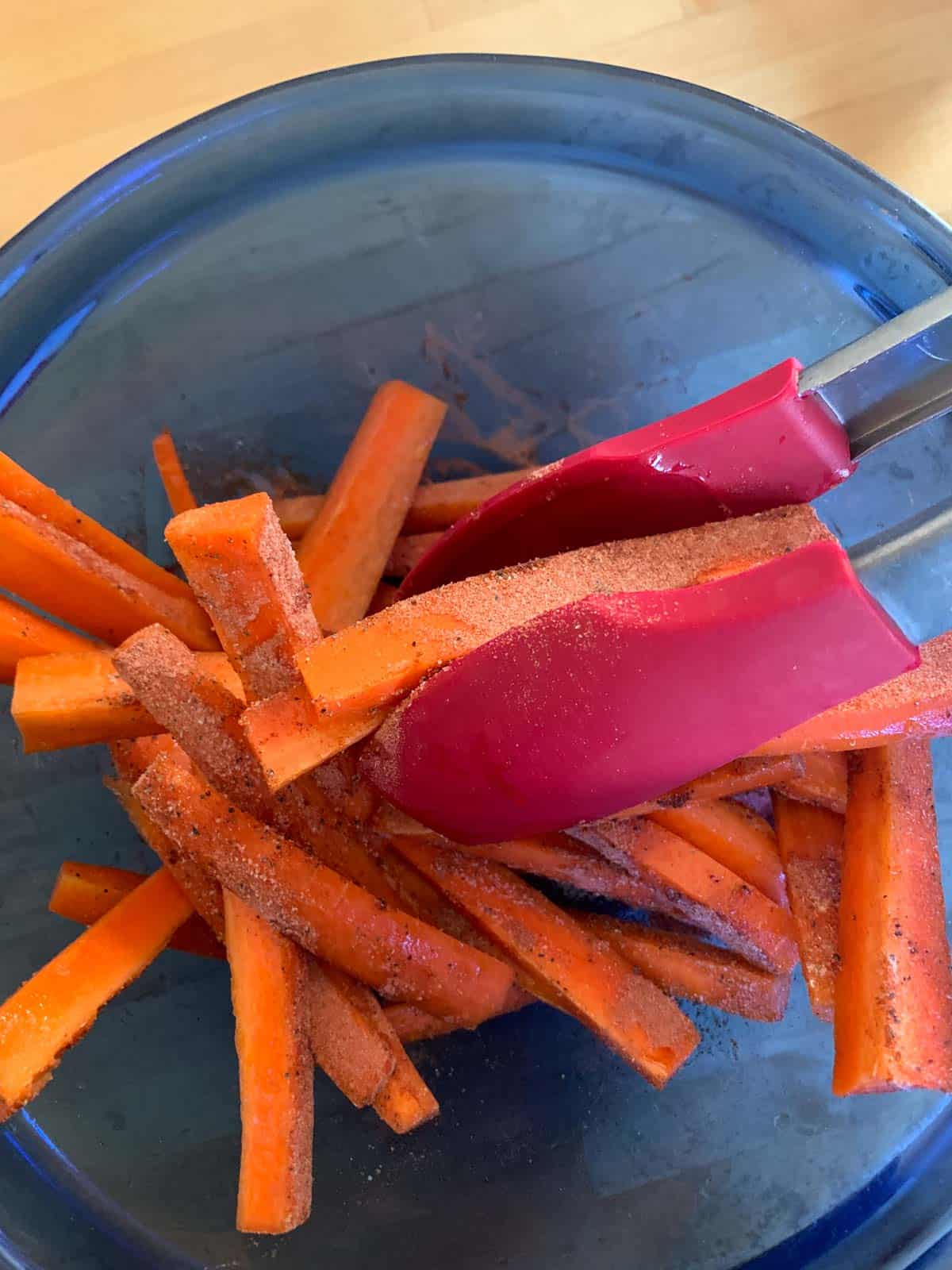 mixing spices onto carrot fries
