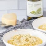bowl of parmesan risotto with cheese and wine