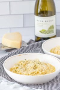 bowl of parmesan risotto with cheese and wine