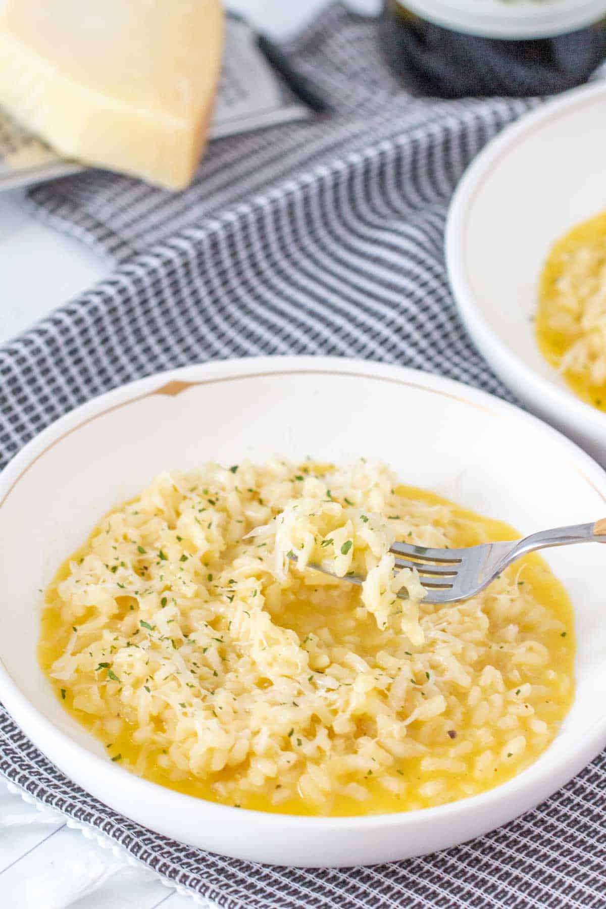 parmesan risotto in bowl with fork