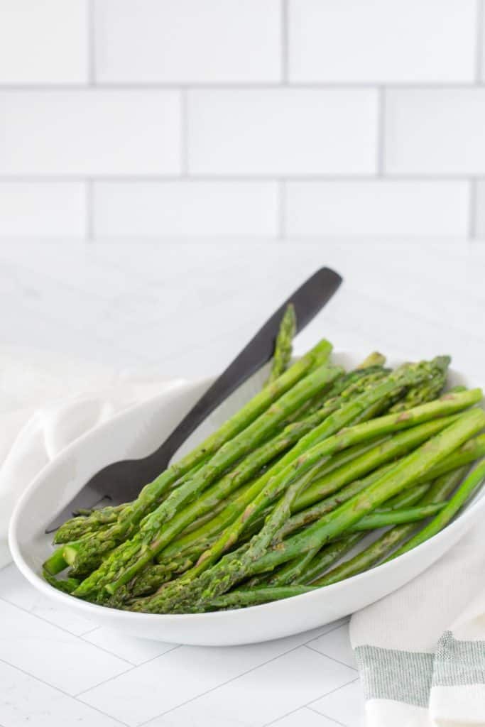 white dish with sauteed asparagus