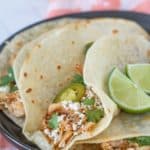 slow cooker shredded chicken tacos with cheese and cilantro