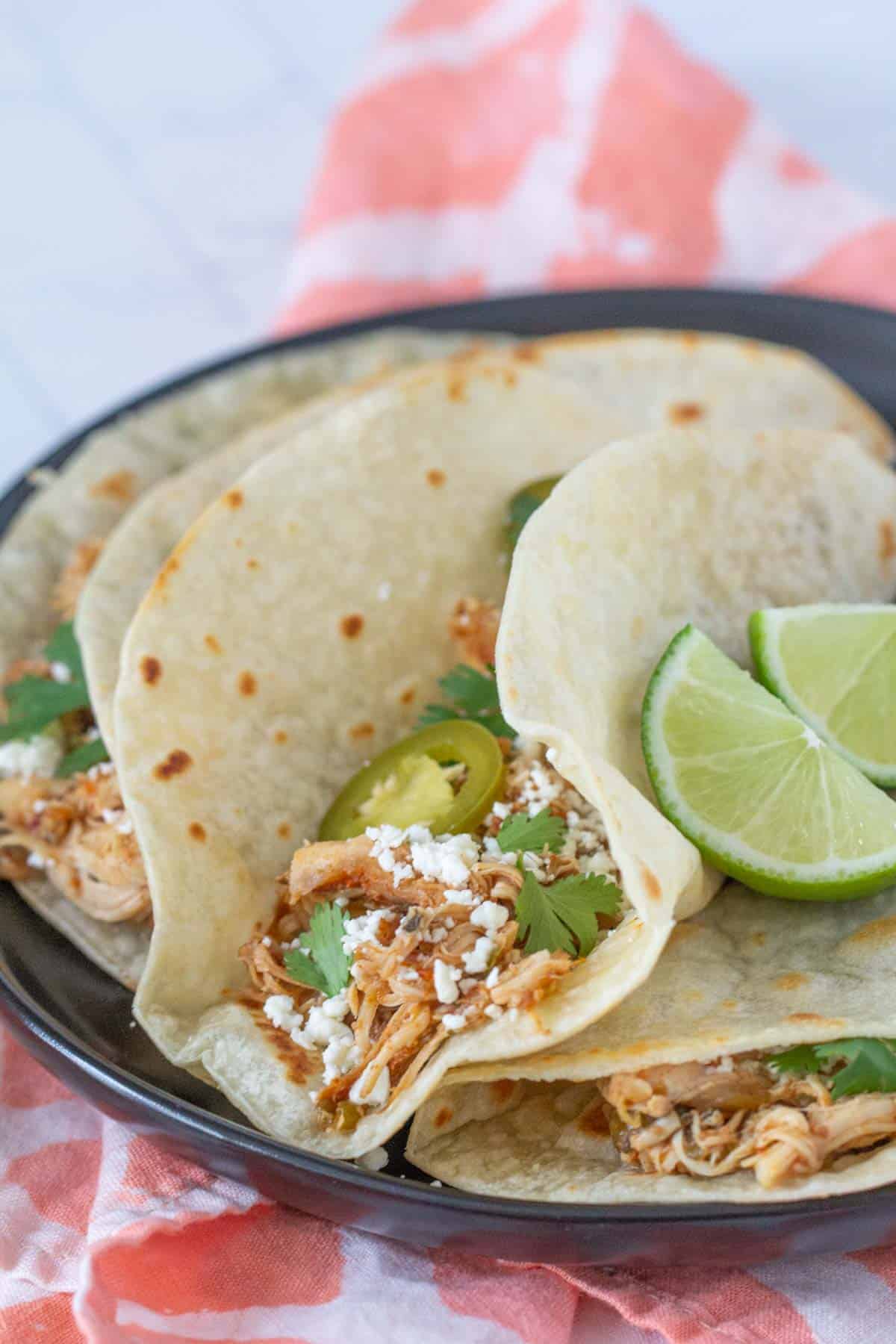slow cooker shredded chicken tacos with cheese and cilantro