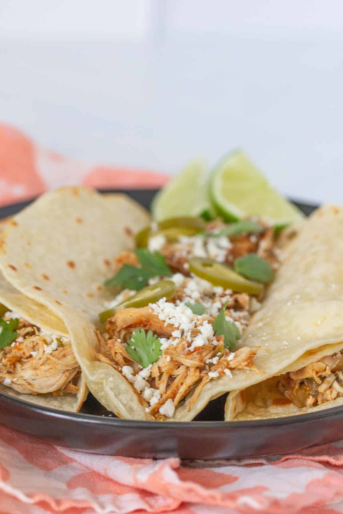 slow cooker shredded chicken tacos with cheese and jalapenos