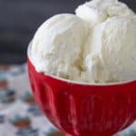 close up vanilla bean ice cream in red bowl