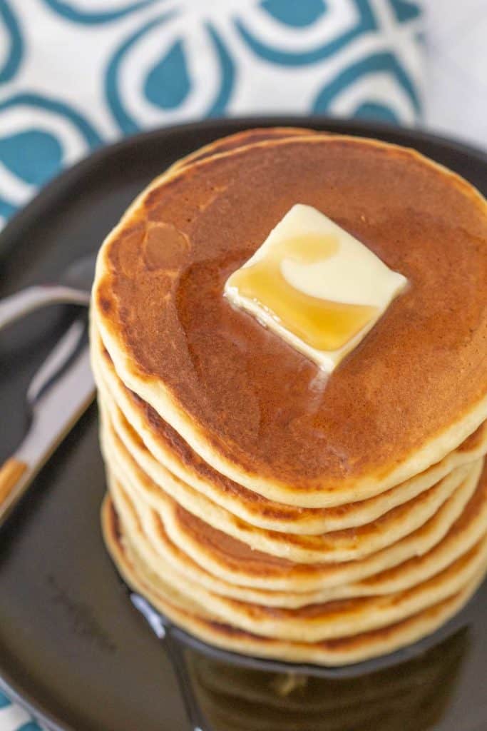 overhead applesauce pancakes with butter and syrup