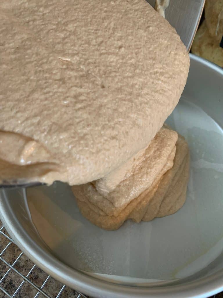 pouring cake batter into pan