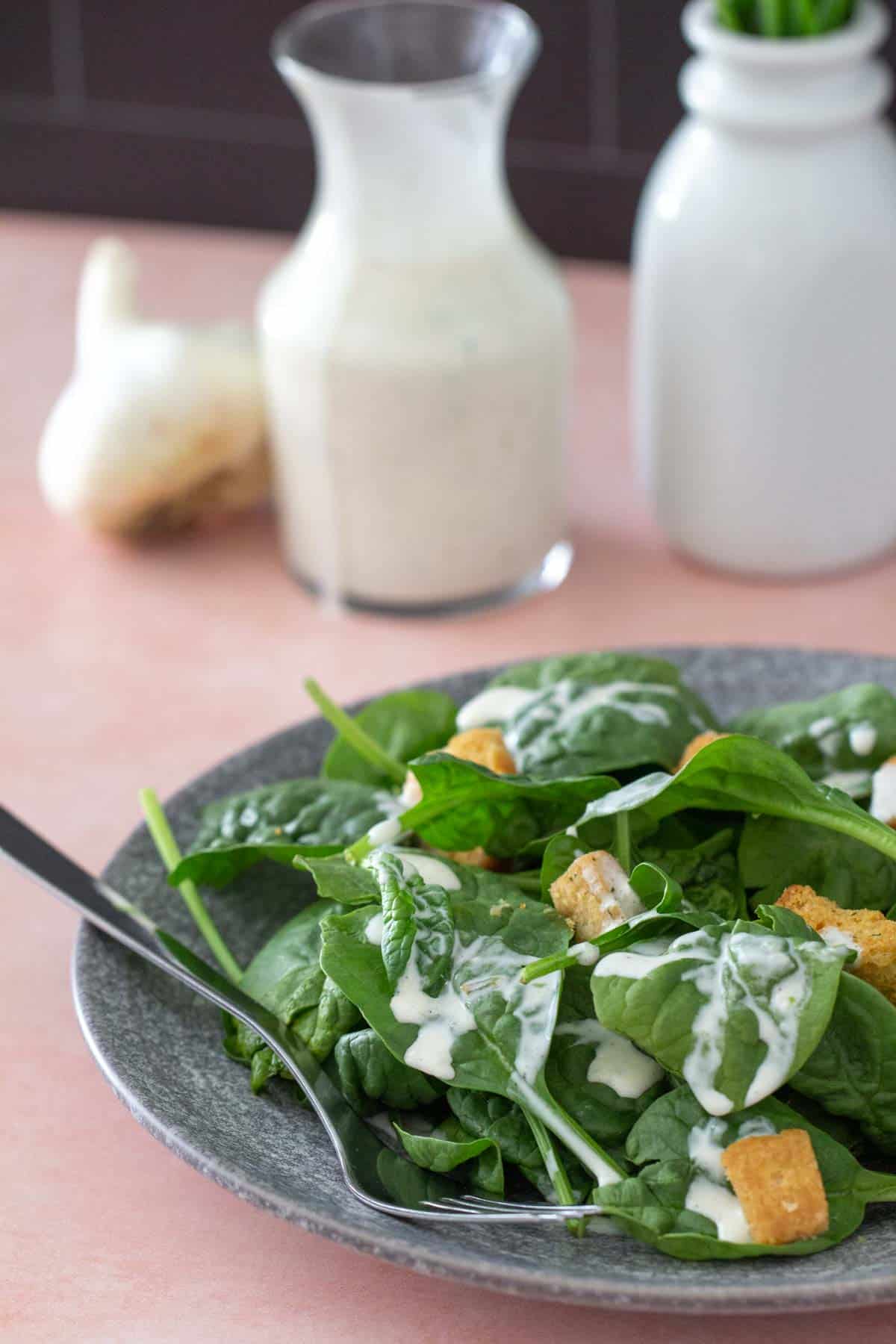 garlic dressing on spinach salad
