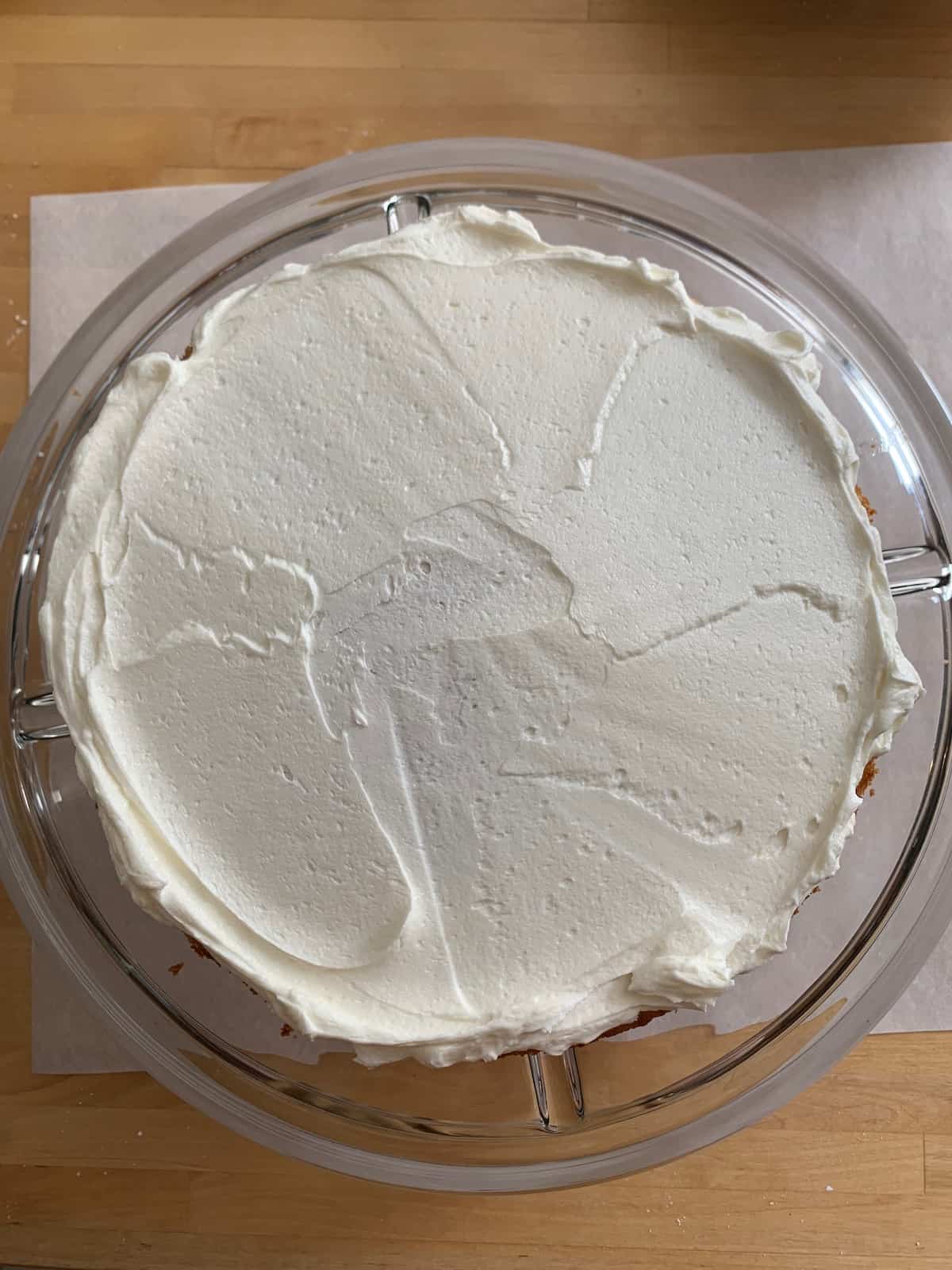 overhead of cake with frosting on bottom layer