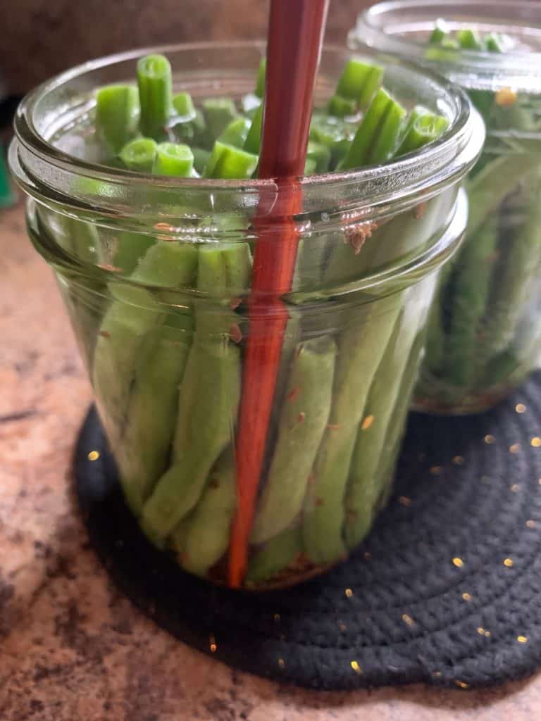 removing air bubbles from canning jar with chopstick