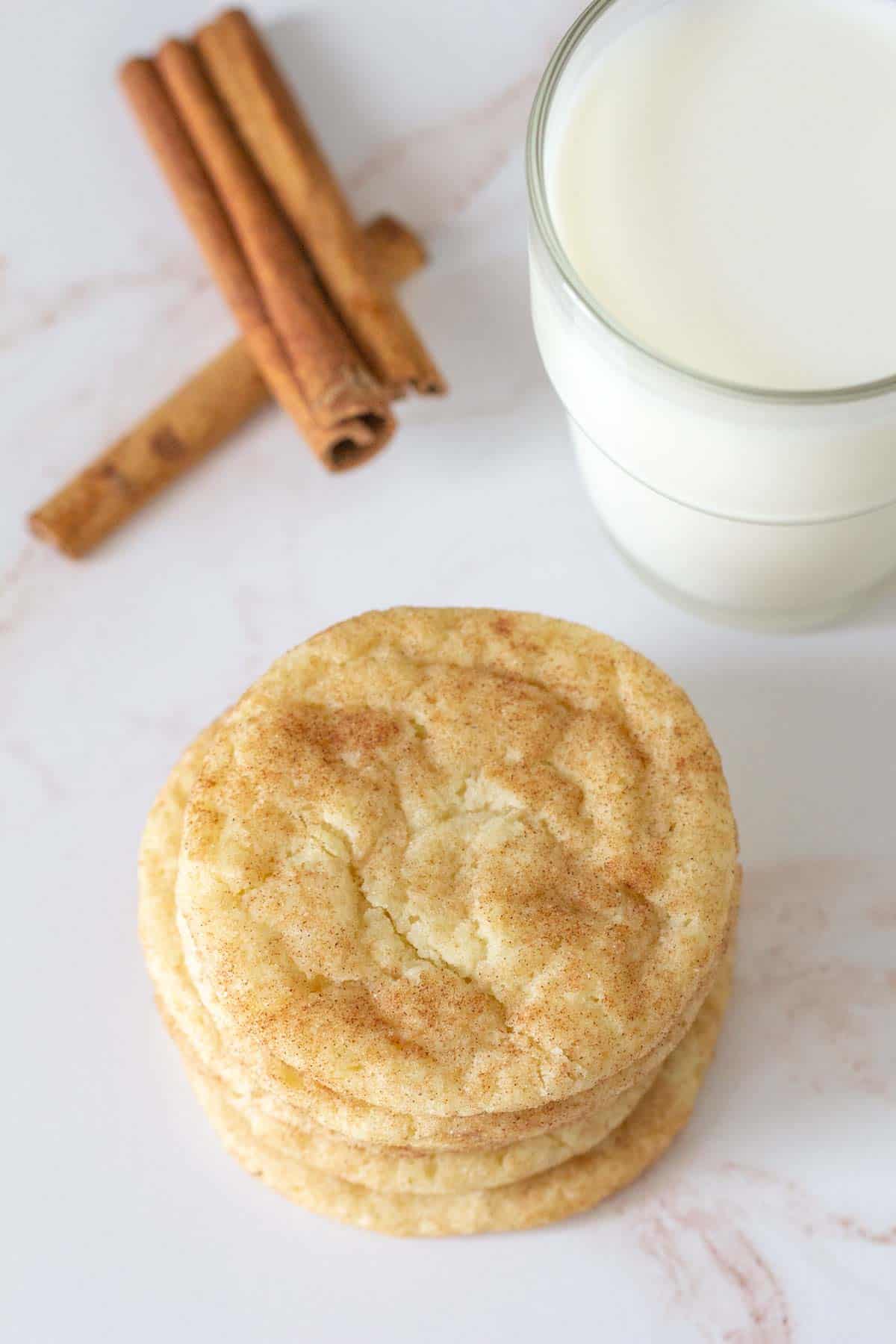 overhead of snickerdoodle cookies stack with milk