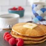 whole wheat pancakes on plate with raspberries