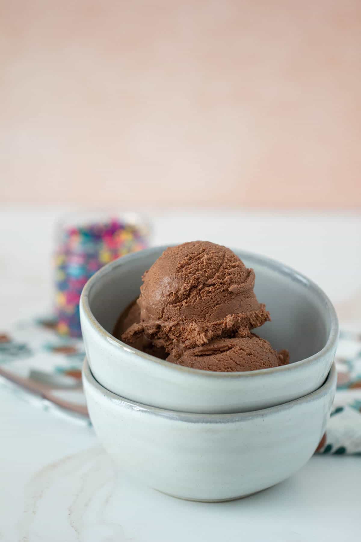 stacked bowls with chocolate ice cream in top bowl