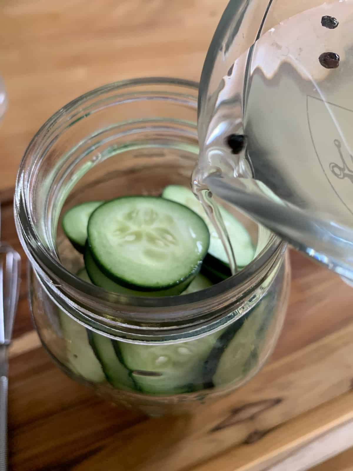 pouring pickling brine into jar