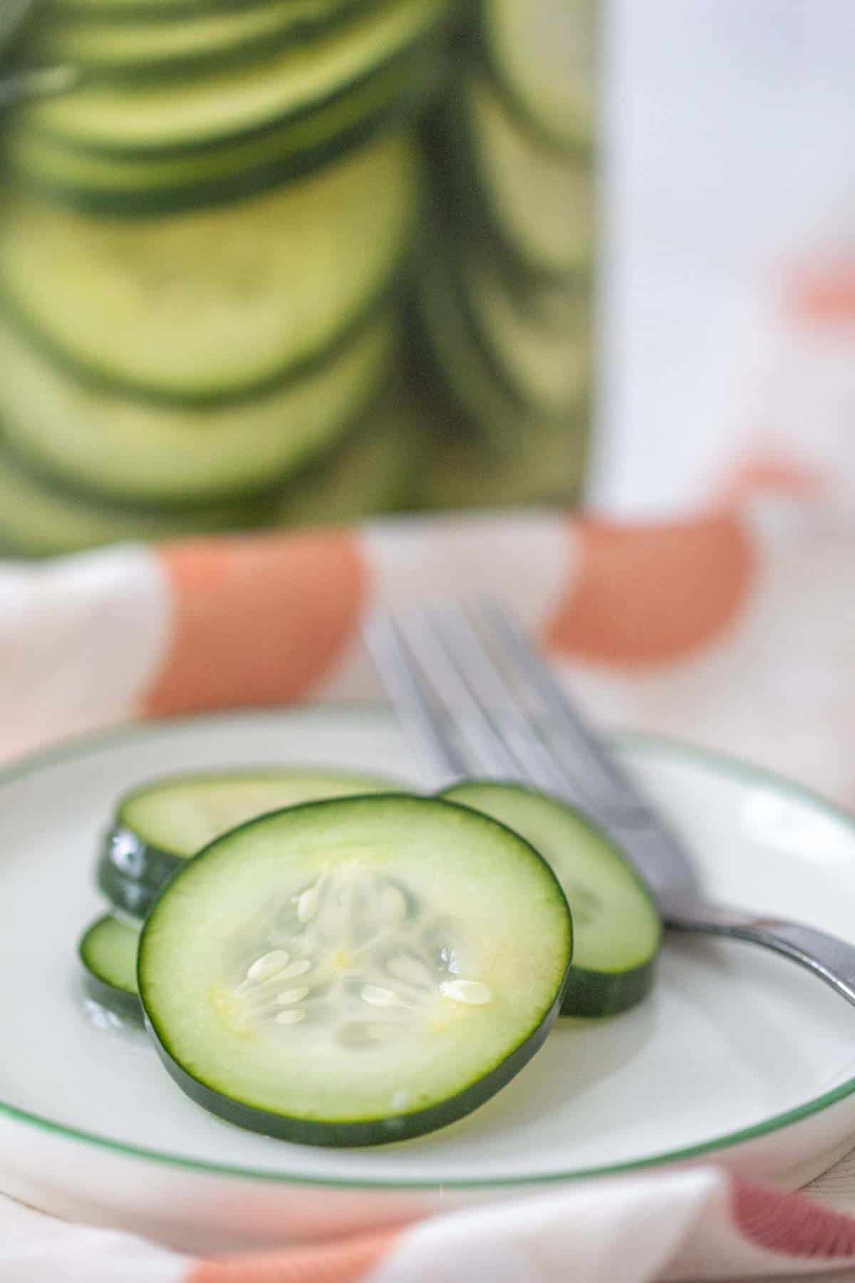quick pickled cucumbers on a plate with a fork