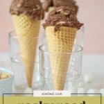 Three waffle cones with scoops of creamy rocky road ice cream are placed upright in clear glasses, surrounded by fluffy marshmallows and a bowl of nuts. Text reads "rocky road ice cream.