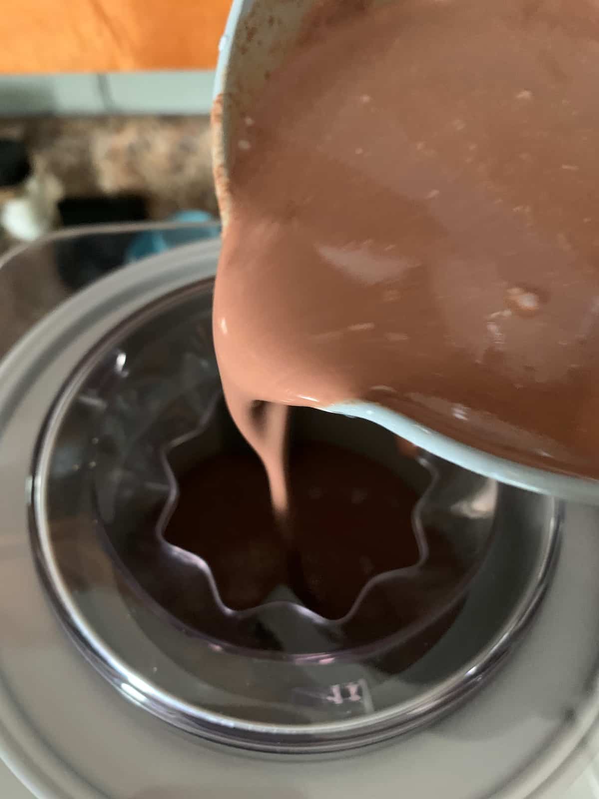 pouring ice cream mixture into machine