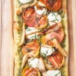 overhead caprese flatbread with chicken on cutting board