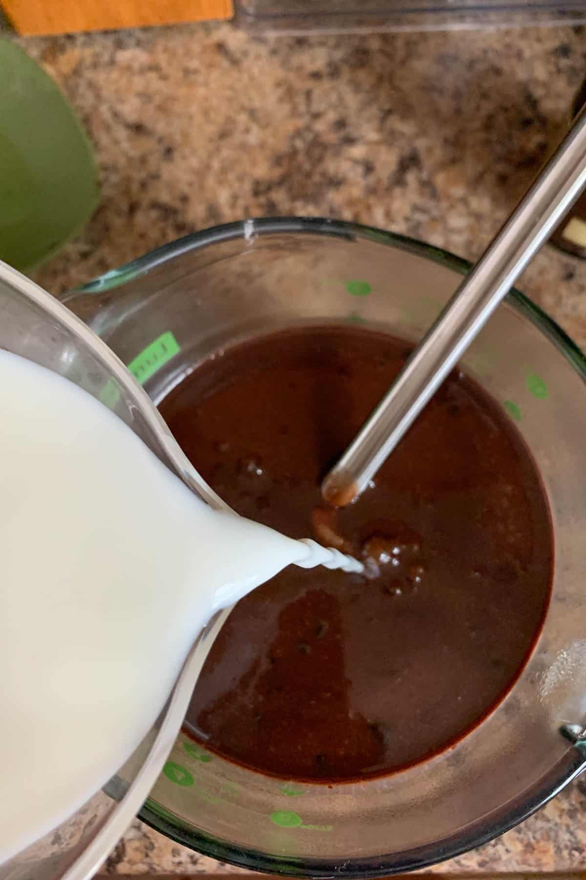 adding milk to chocolate ice cream base