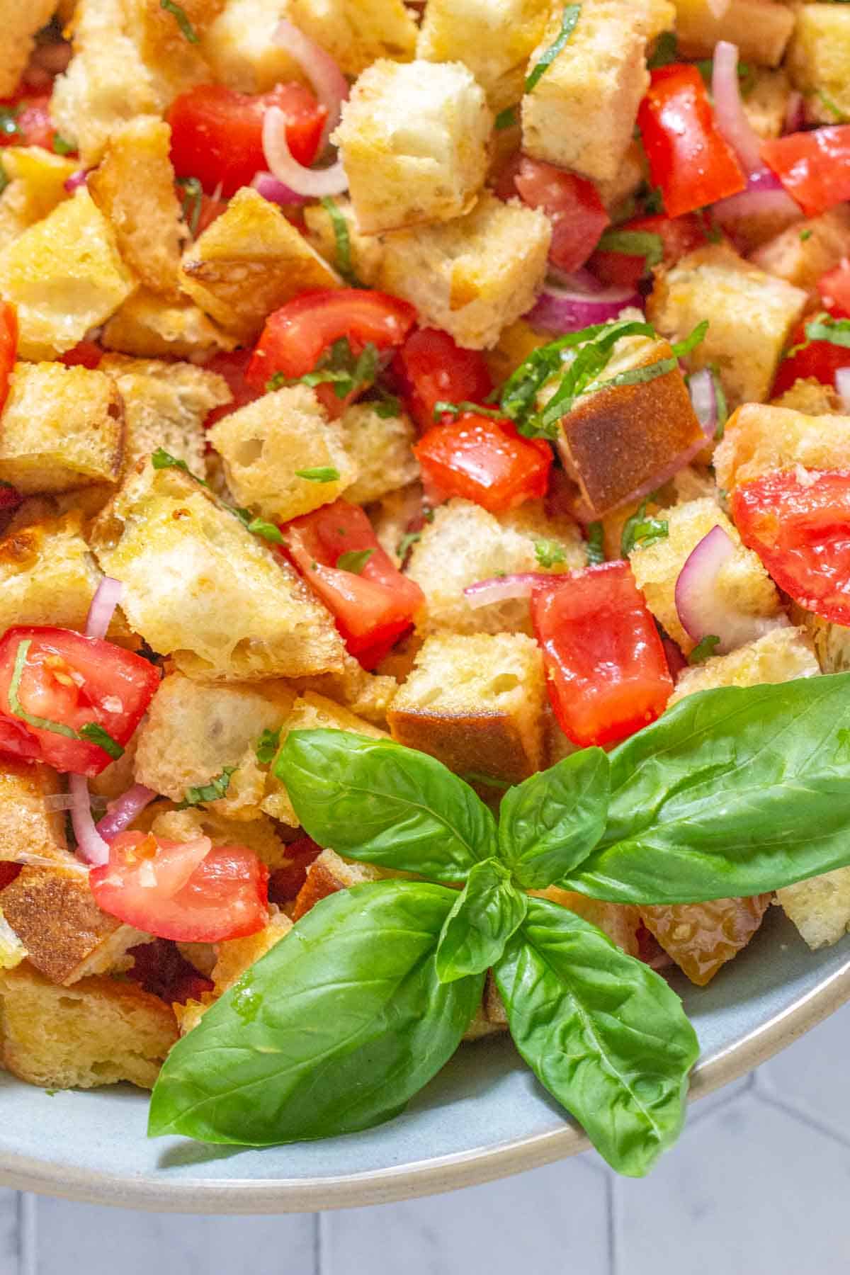 close up of panzanella salad with basil leaves