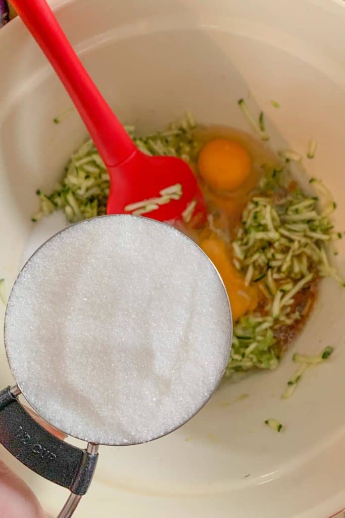 adding sugar to zucchini bread batter