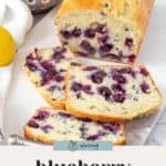 A loaf of blueberry bread partially sliced, revealing juicy blueberries inside. A bowl of fresh blueberries and a lemon are in the background. Text reads "blueberry bread.
