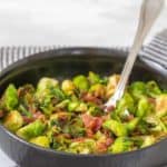 maple bacon brussels sprouts in black bowl