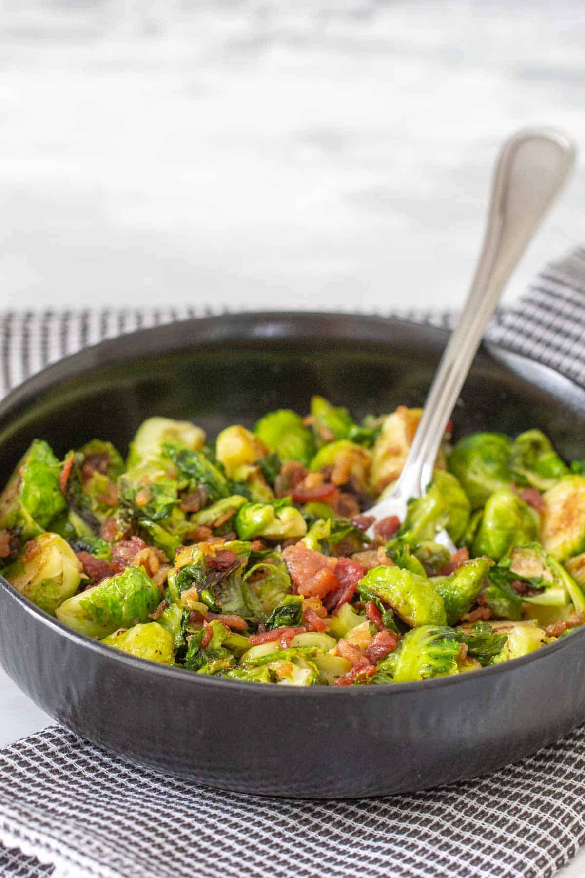 maple bacon brussels sprouts in black bowl