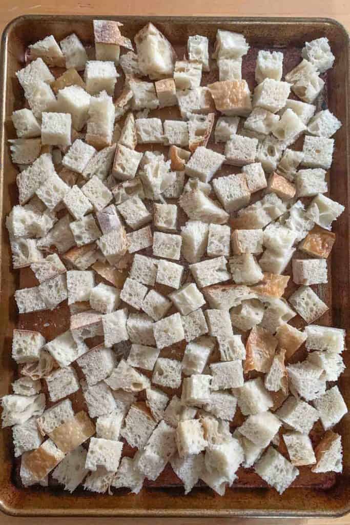 cubed bread on baking sheet