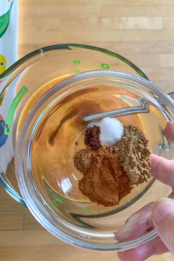 adding spices to pumpkin ice cream custard