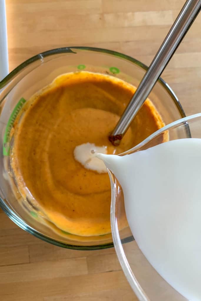adding milk to pumpkin ice cream custard