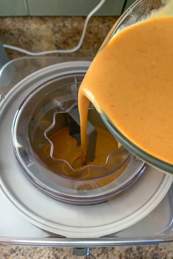 pouring pumpkin ice cream custard into ice cream machine