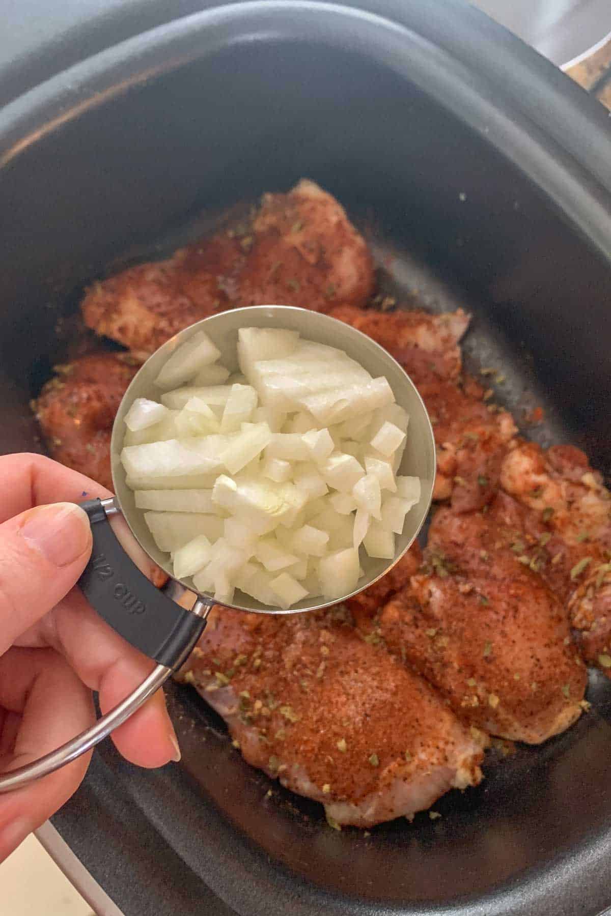 adding onions to slow cooker chicken tacos