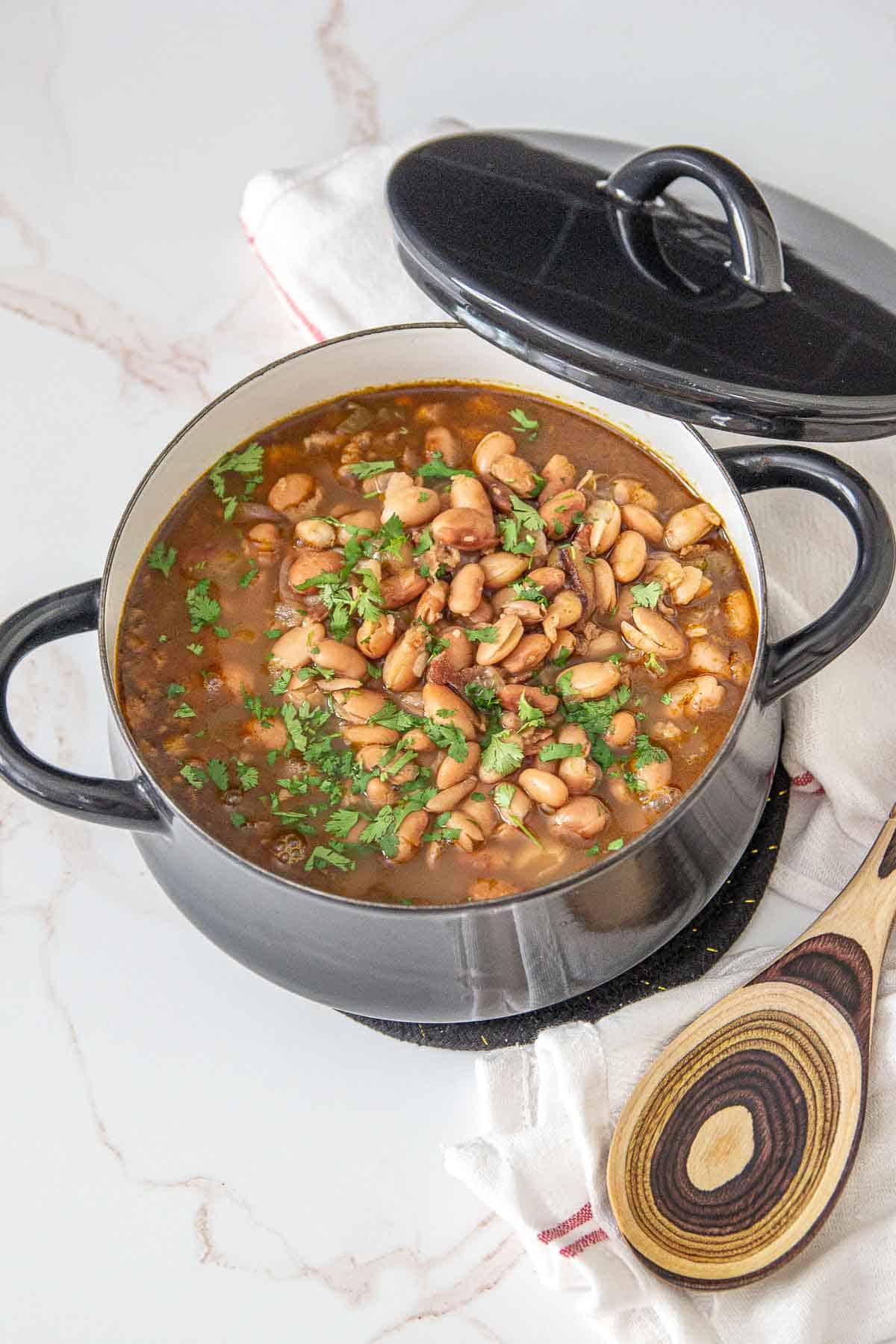 borracho beans in a black serving pot