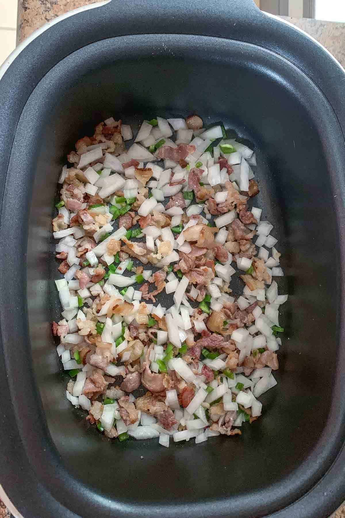 sauteing onion and jalapeno in slow cooker with bacon
