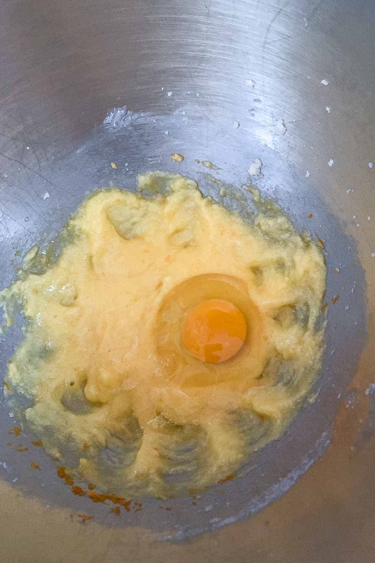 adding egg to muffin batter