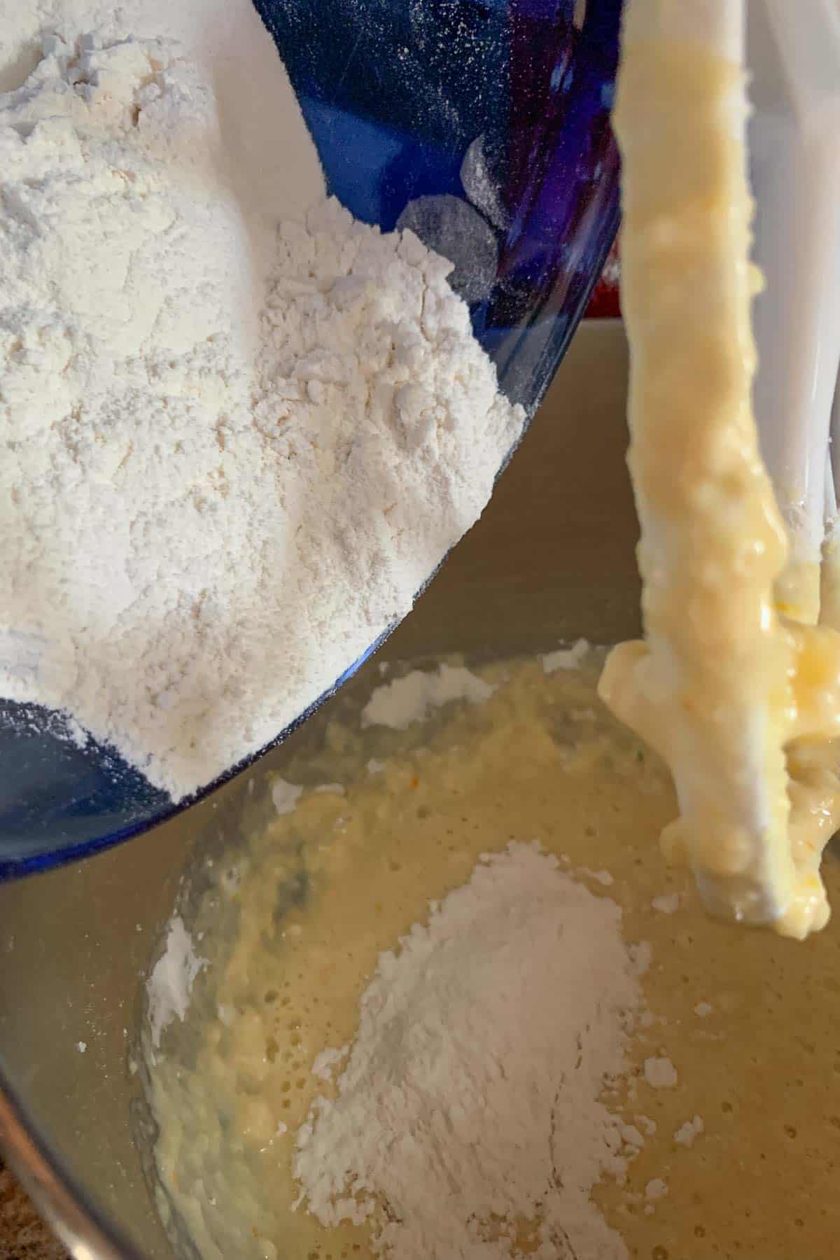 adding dry ingredients to muffin batter