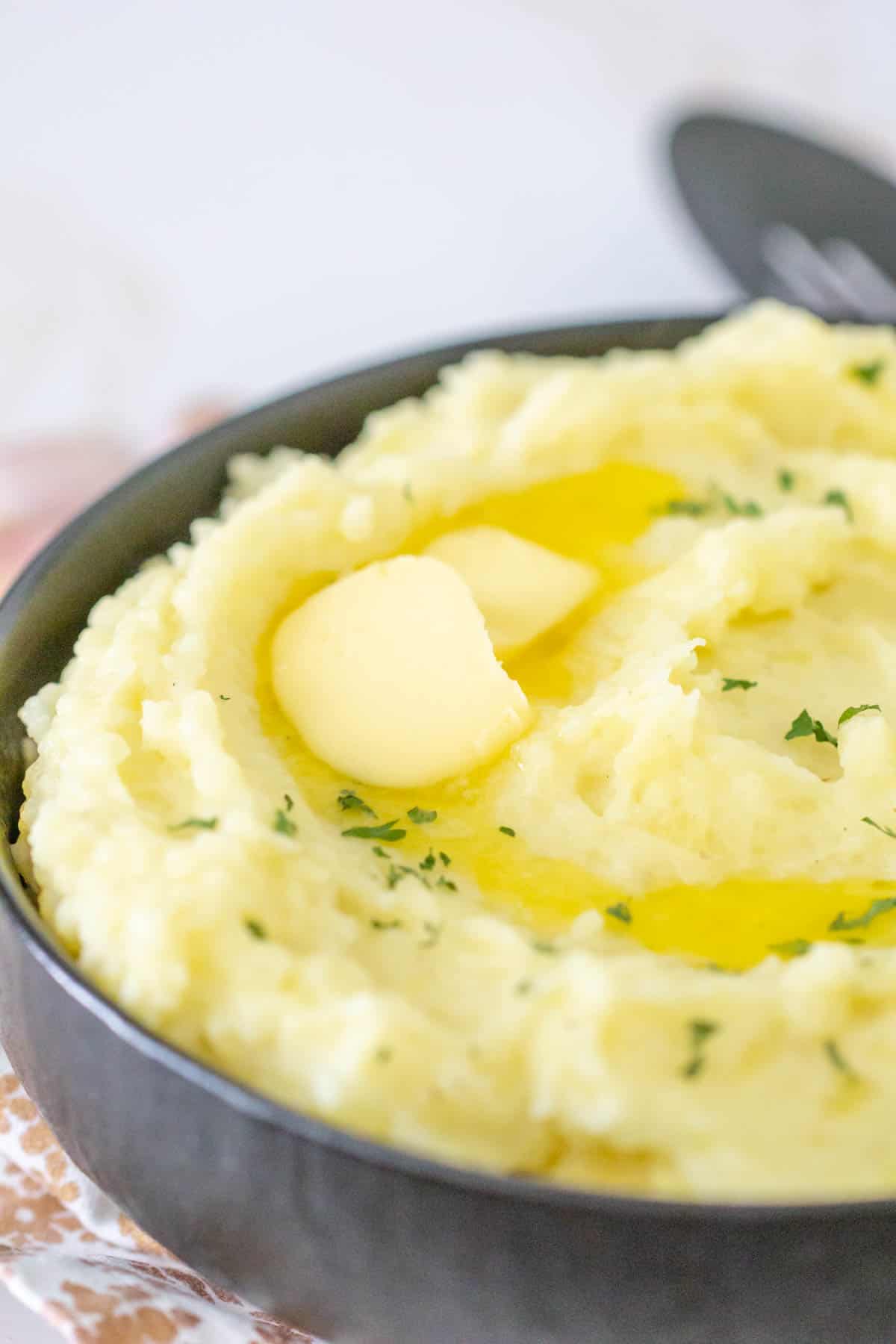 close up of butter melting on garlic mashed potatoes