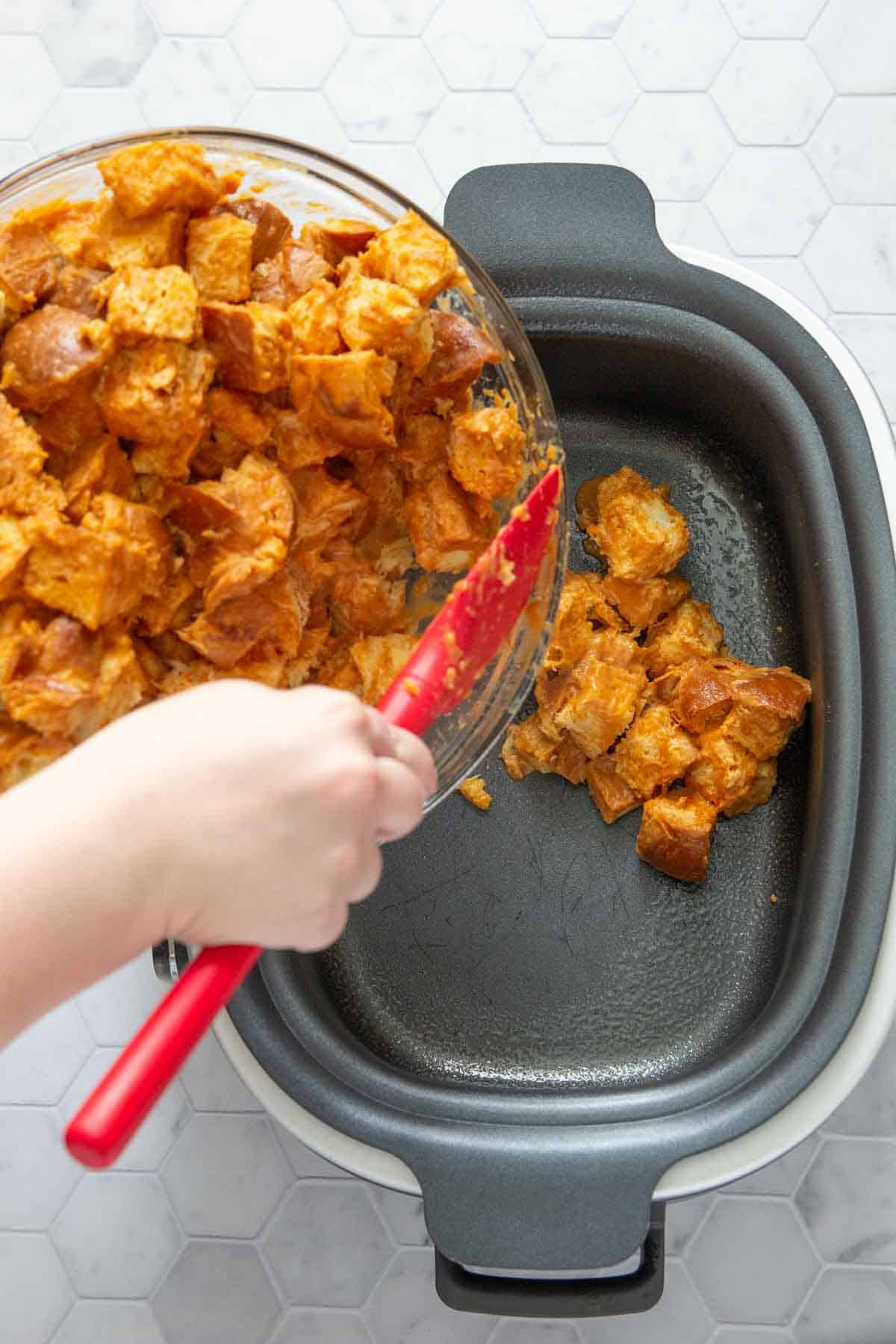 adding pumpkin french toast pieces to slow cooker