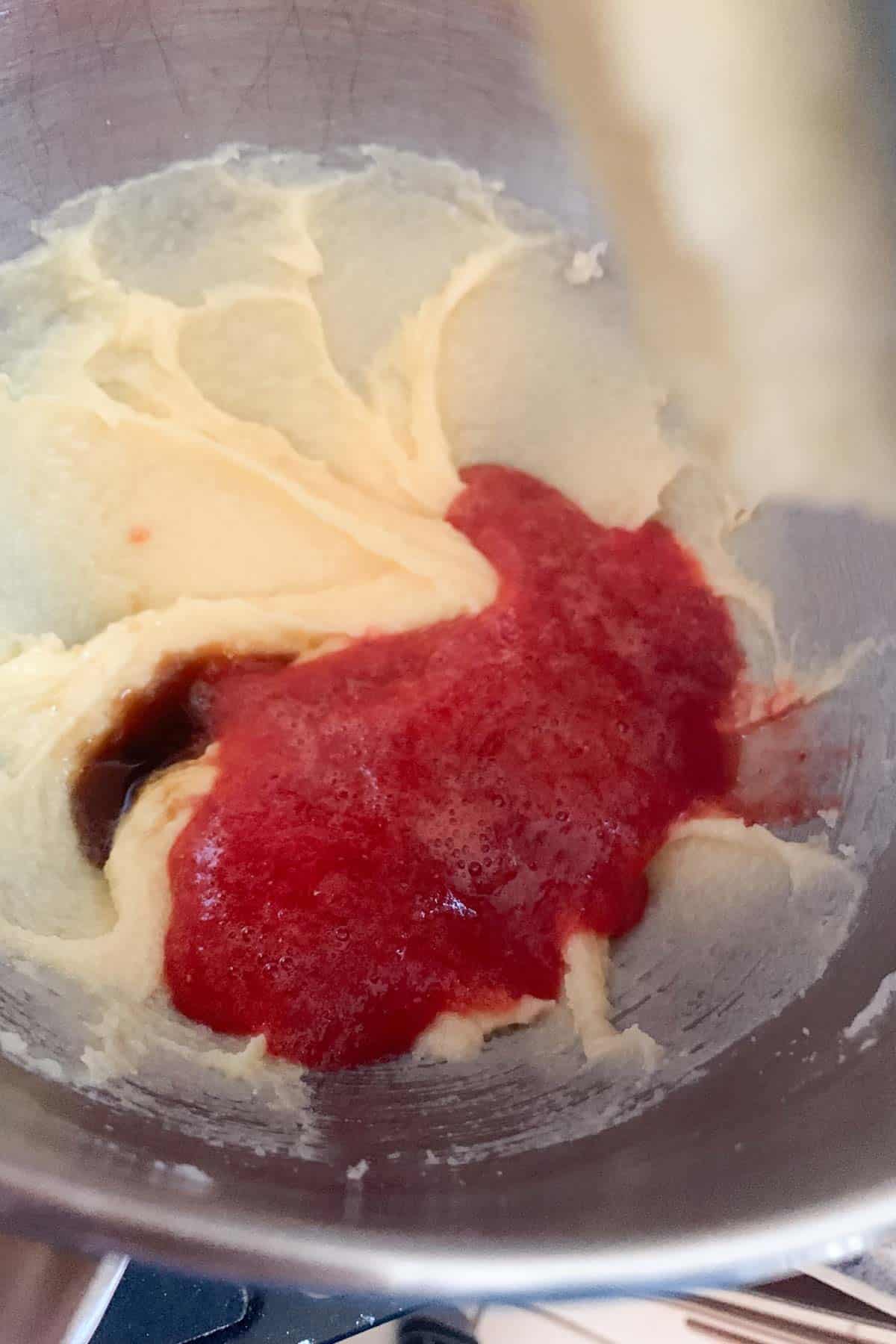 adding strawberry puree to cupcake batter